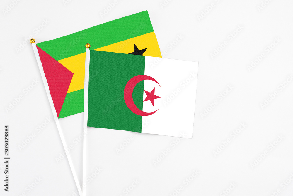 Algeria and Saudi Arabia stick flags on white background. High quality fabric, miniature national flag. Peaceful global concept.White floor for copy space. Algeria and Saudi Arabia stick flags on white background. High quality fabric, miniature national flag. Peaceful global concept.White floor for copy space.
