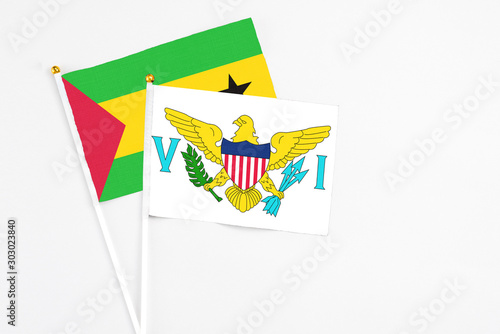 United States Virgin Islands and Sao Tome And Principe stick flags on white background. High quality fabric, miniature national flag. Peaceful global concept.White floor for copy space.