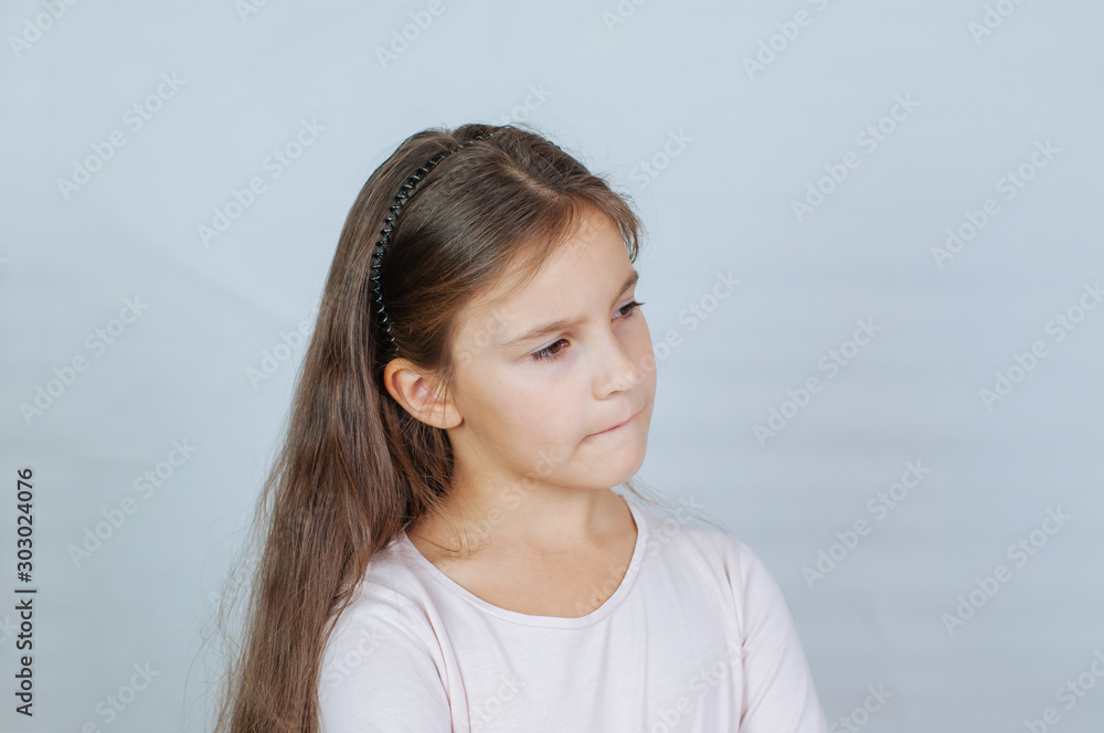 Little pretty girl with long hair, age 6-7 years old, expresses aggressive evil emotions Little pretty girl with long hair, age 6-7 years old, expresses aggressive evil emotions