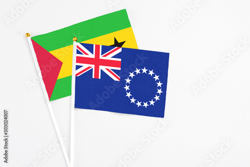 Cook Islands and Saudi Arabia stick flags on white background. High quality fabric, miniature national flag. Peaceful global concept.White floor for copy space.