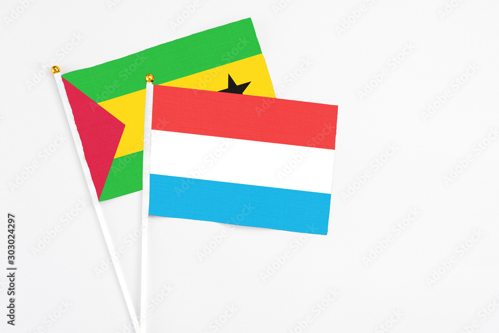 Luxembourg and Saudi Arabia stick flags on white background. High quality fabric, miniature national flag. Peaceful global concept.White floor for copy space. Luxembourg and Saudi Arabia stick flags on white background. High quality fabric, miniature national flag. Peaceful global concept.White floor for copy space.