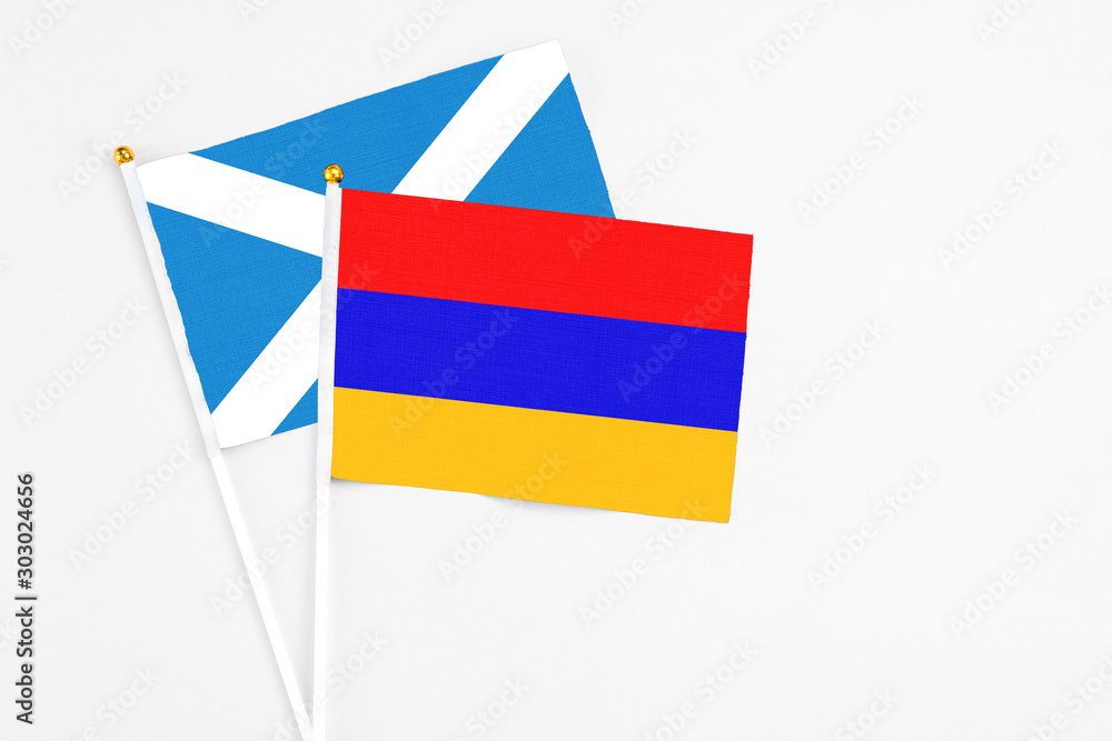 Armenia and Scotland stick flags on white background. High quality fabric, miniature national flag. Peaceful global concept.White floor for copy space. Armenia and Scotland stick flags on white background. High quality fabric, miniature national flag. Peaceful global concept.White floor for copy space.
