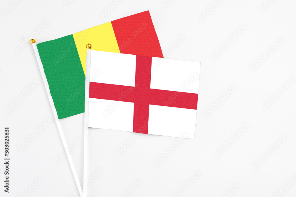 England and Senegal stick flags on white background. High quality fabric, miniature national flag. Peaceful global concept.White floor for copy space.
