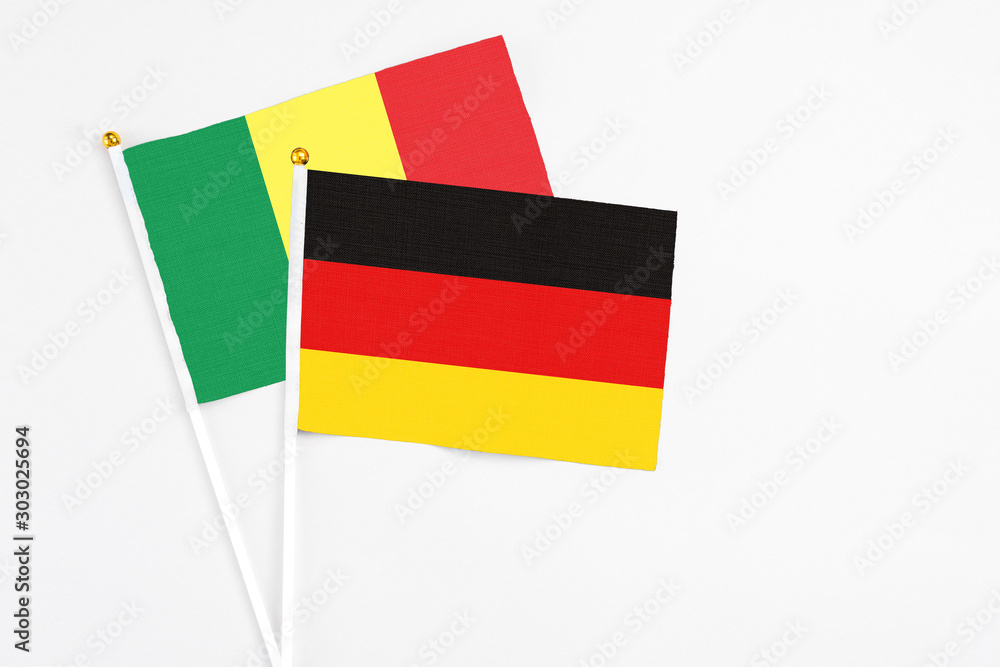 Obraz premium Germany and Senegal stick flags on white background. High quality fabric, miniature national flag. Peaceful global concept.White floor for copy space.