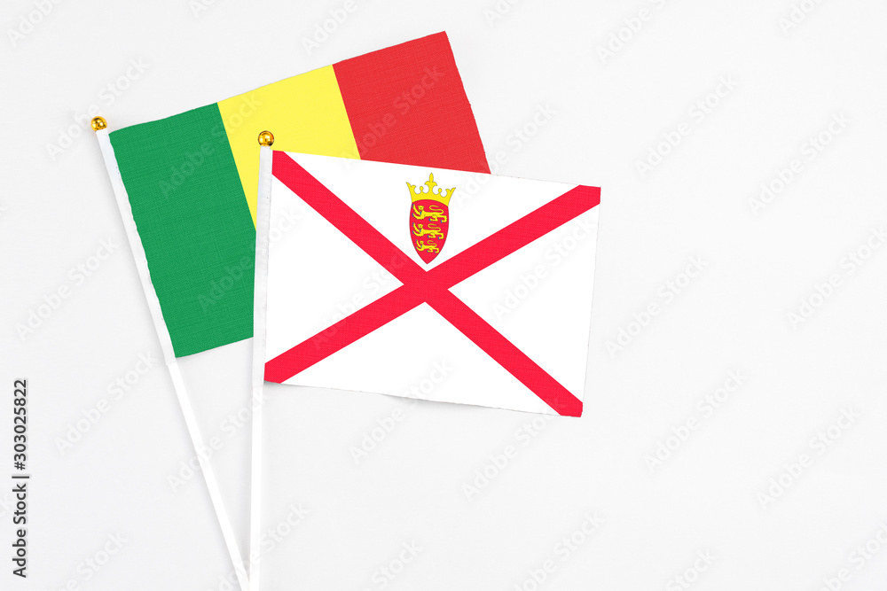 Jersey and Senegal stick flags on white background. High quality fabric, miniature national flag. Peaceful global concept.White floor for copy space. Jersey and Senegal stick flags on white background. High quality fabric, miniature national flag. Peaceful global concept.White floor for copy space.