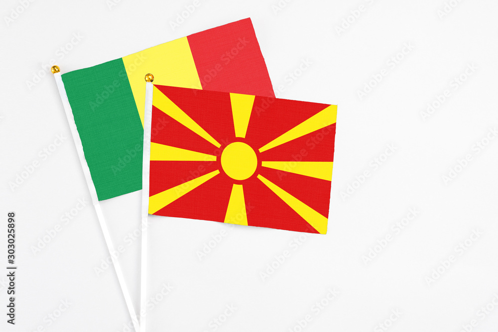 Macedonia and Senegal stick flags on white background. High quality fabric, miniature national flag. Peaceful global concept.White floor for copy space.