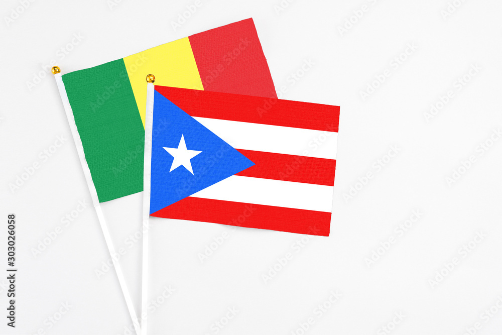 Puerto Rico and Senegal stick flags on white background. High quality fabric, miniature national flag. Peaceful global concept.White floor for copy space. Puerto Rico and Senegal stick flags on white background. High quality fabric, miniature national flag. Peaceful global concept.White floor for copy space.