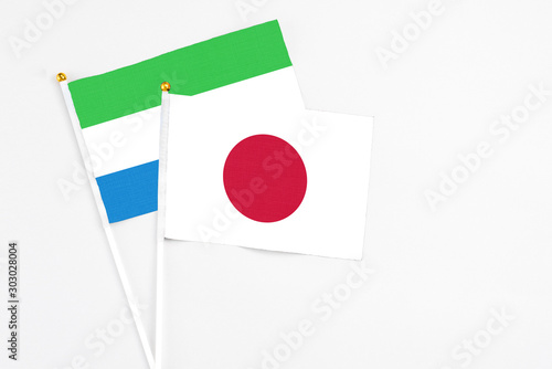 Japan and Sierra Leone stick flags on white background. High quality fabric, miniature national flag. Peaceful global concept.White floor for copy space. Free Download Japan and Sierra Leone stick flags on white background. High quality fabric, miniature national flag. Peaceful global concept.White floor for copy space. - GFXLoad