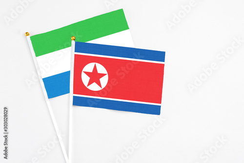 North Korea and Sierra Leone stick flags on white background. High quality fabric, miniature national flag. Peaceful global concept.White floor for copy space. Free Download North Korea and Sierra Leone stick flags on white background. High quality fabric, miniature national flag. Peaceful global concept.White floor for copy space. - GFXLoad