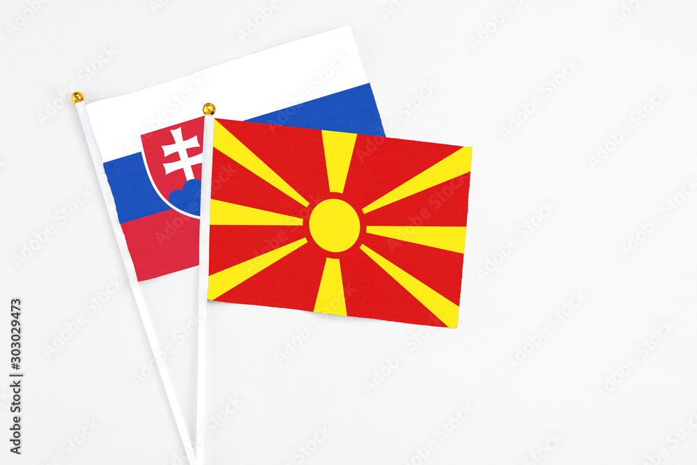 Macedonia and Slovakia stick flags on white background. High quality fabric, miniature national flag. Peaceful global concept.White floor for copy space.
