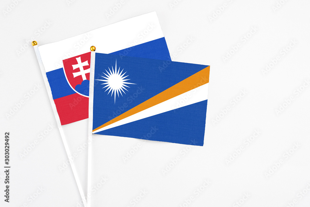 Marshall Islands and Slovakia stick flags on white background. High quality fabric, miniature national flag. Peaceful global concept.White floor for copy space. Marshall Islands and Slovakia stick flags on white background. High quality fabric, miniature national flag. Peaceful global concept.White floor for copy space.