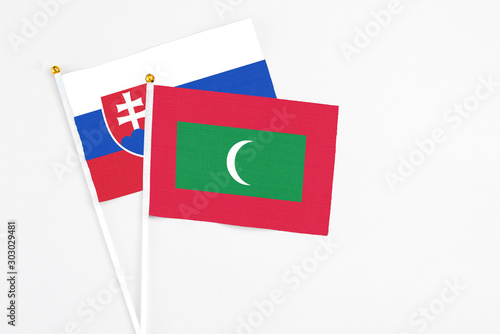 Free Download Maldives and Slovakia stick flags on white background. High quality fabric, miniature national flag. Peaceful global concept.White floor for copy space. - GFXLoad