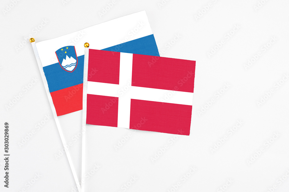 Denmark and Slovenia stick flags on white background. High quality fabric, miniature national flag. Peaceful global concept.White floor for copy space.