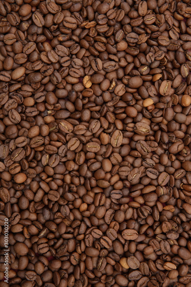 roasted coffee beans background. Arabica. Flat lay. Top view. Pattern, background, texture. Coffee concept. Vertical photo. roasted coffee beans background. Arabica. Flat lay. Top view. Pattern, background, texture. Coffee concept. Vertical photo.