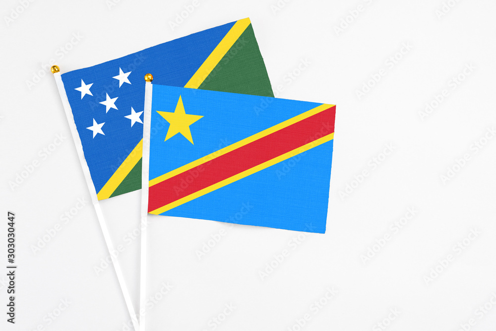 Congo and Solomon Islands stick flags on white background. High quality fabric, miniature national flag. Peaceful global concept.White floor for copy space. Congo and Solomon Islands stick flags on white background. High quality fabric, miniature national flag. Peaceful global concept.White floor for copy space.