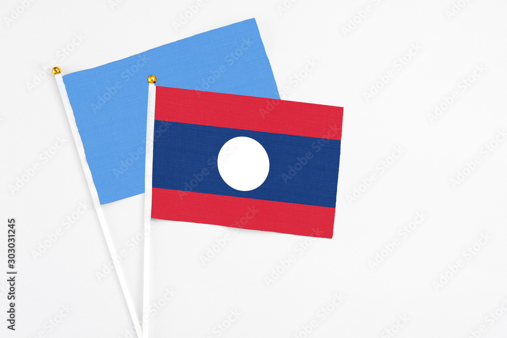 Laos and Somalia stick flags on white background. High quality fabric, miniature national flag. Peaceful global concept.White floor for copy space. Laos and Somalia stick flags on white background. High quality fabric, miniature national flag. Peaceful global concept.White floor for copy space.