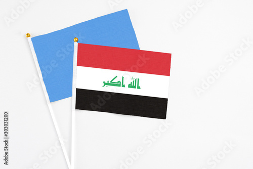 Free Download Iraq and Somalia stick flags on white background. High quality fabric, miniature national flag. Peaceful global concept.White floor for copy space. - GFXLoad