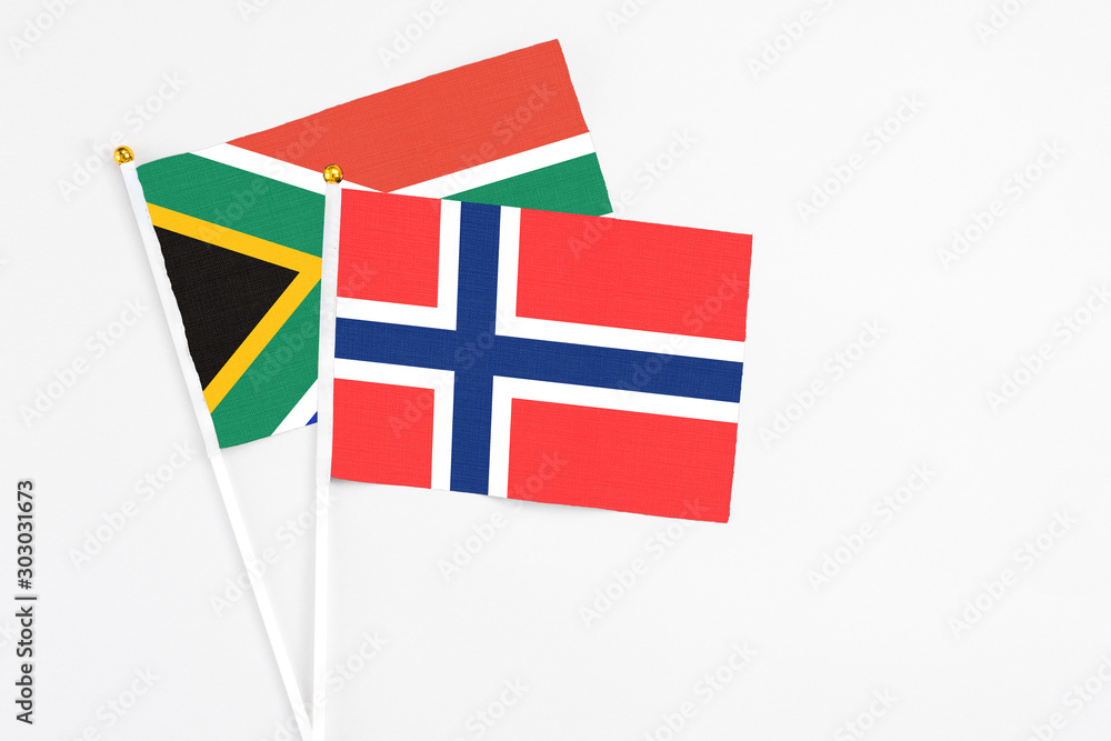 Bouvet Islands and South Africa stick flags on white background. High quality fabric, miniature national flag. Peaceful global concept.White floor for copy space. Bouvet Islands and South Africa stick flags on white background. High quality fabric, miniature national flag. Peaceful global concept.White floor for copy space.