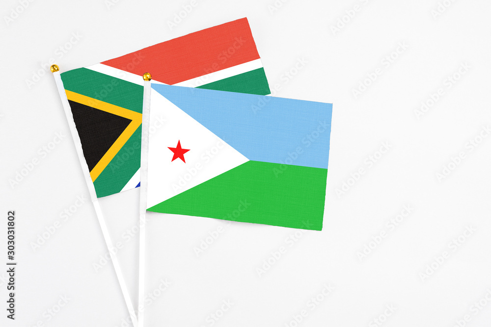 Djibouti and South Africa stick flags on white background. High quality fabric, miniature national flag. Peaceful global concept.White floor for copy space. Djibouti and South Africa stick flags on white background. High quality fabric, miniature national flag. Peaceful global concept.White floor for copy space.