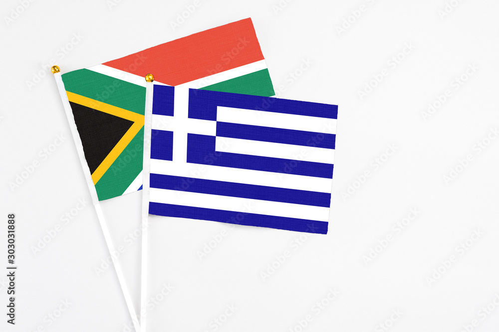 Greece and South Africa stick flags on white background. High quality fabric, miniature national flag. Peaceful global concept.White floor for copy space. Greece and South Africa stick flags on white background. High quality fabric, miniature national flag. Peaceful global concept.White floor for copy space.