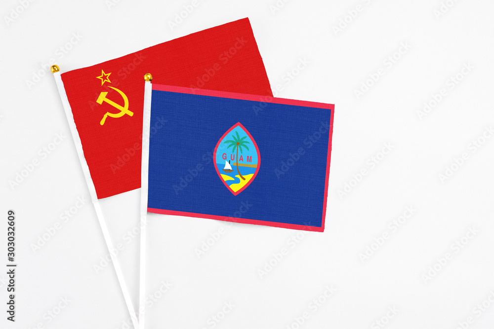 Guam and Soviet Union stick flags on white background. High quality fabric, miniature national flag. Peaceful global concept.White floor for copy space. Guam and Soviet Union stick flags on white background. High quality fabric, miniature national flag. Peaceful global concept.White floor for copy space.