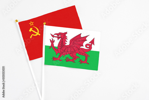 Wales and Soviet Union stick flags on white background. High quality fabric  miniature national flag. Peaceful global concept.White floor for copy space.