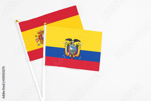 Ecuador and Spain stick flags on white background. High quality fabric, miniature national flag. Peaceful global concept.White floor for copy space.