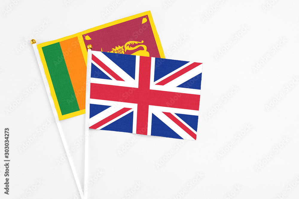 and Sri Lanka stick flags on white background. High quality fabric, miniature national flag. Peaceful global concept.White floor for copy space. and Sri Lanka stick flags on white background. High quality fabric, miniature national flag. Peaceful global concept.White floor for copy space.