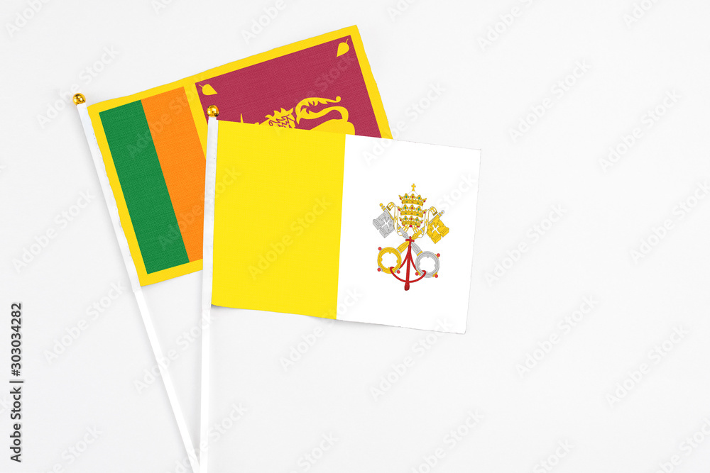 and Sri Lanka stick flags on white background. High quality fabric, miniature national flag. Peaceful global concept.White floor for copy space. and Sri Lanka stick flags on white background. High quality fabric, miniature national flag. Peaceful global concept.White floor for copy space.