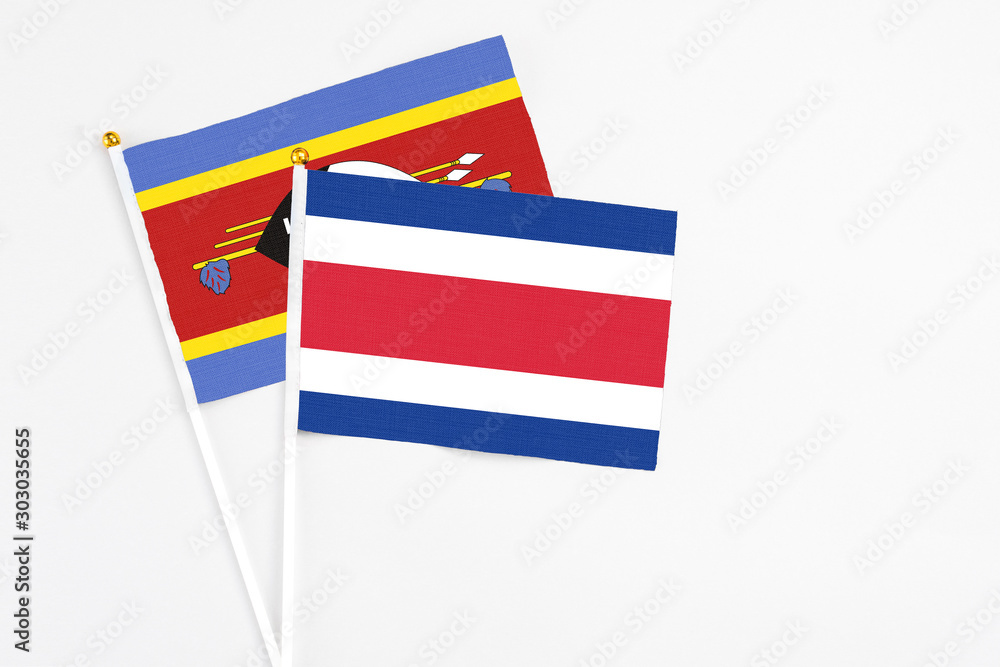 Costa Rica and Swaziland stick flags on white background. High quality fabric, miniature national flag. Peaceful global concept.White floor for copy space. Costa Rica and Swaziland stick flags on white background. High quality fabric, miniature national flag. Peaceful global concept.White floor for copy space.