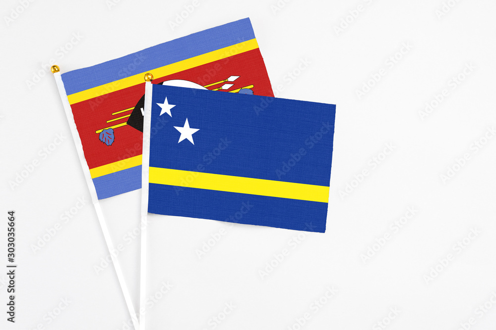 Curacao and Swaziland stick flags on white background. High quality fabric, miniature national flag. Peaceful global concept.White floor for copy space. Curacao and Swaziland stick flags on white background. High quality fabric, miniature national flag. Peaceful global concept.White floor for copy space.