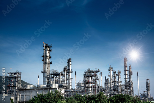 Close-up view Oil and gas industrial refinery zone,Detail of equipment oil pipeline steel with valve from large oil storage tank at cloudy sky. -image