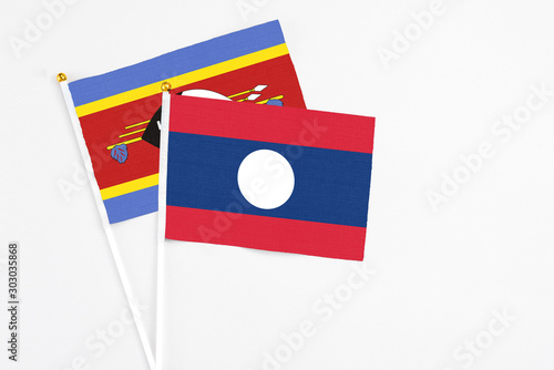 Laos and Swaziland stick flags on white background. High quality fabric, miniature national flag. Peaceful global concept.White floor for copy space. Free Download Laos and Swaziland stick flags on white background. High quality fabric, miniature national flag. Peaceful global concept.White floor for copy space. - GFXLoad
