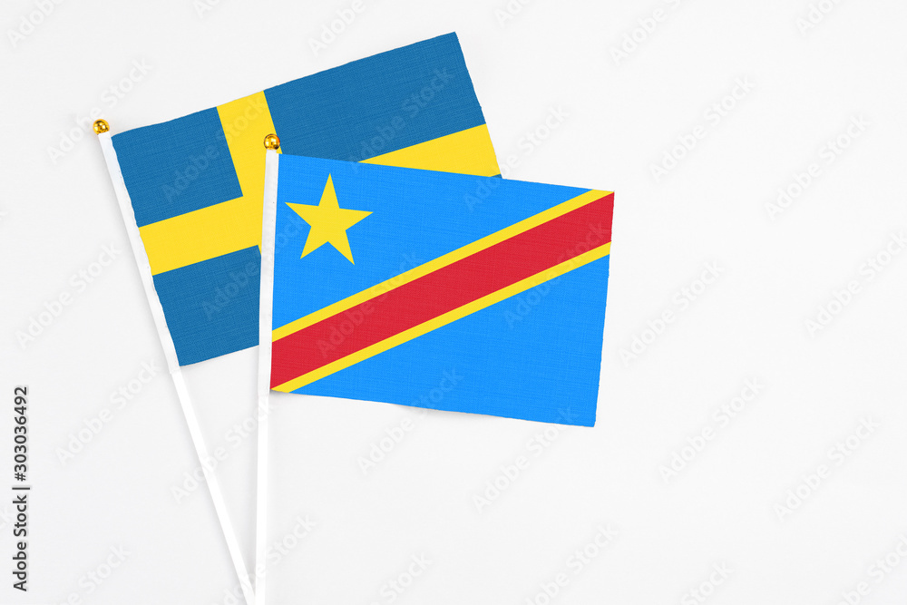 Congo and Sweden stick flags on white background. High quality fabric, miniature national flag. Peaceful global concept.White floor for copy space. Congo and Sweden stick flags on white background. High quality fabric, miniature national flag. Peaceful global concept.White floor for copy space.
