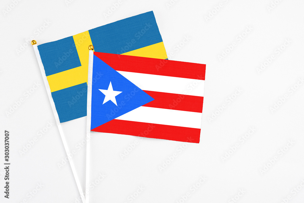 Puerto Rico and Sweden stick flags on white background. High quality fabric, miniature national flag. Peaceful global concept.White floor for copy space. Puerto Rico and Sweden stick flags on white background. High quality fabric, miniature national flag. Peaceful global concept.White floor for copy space.