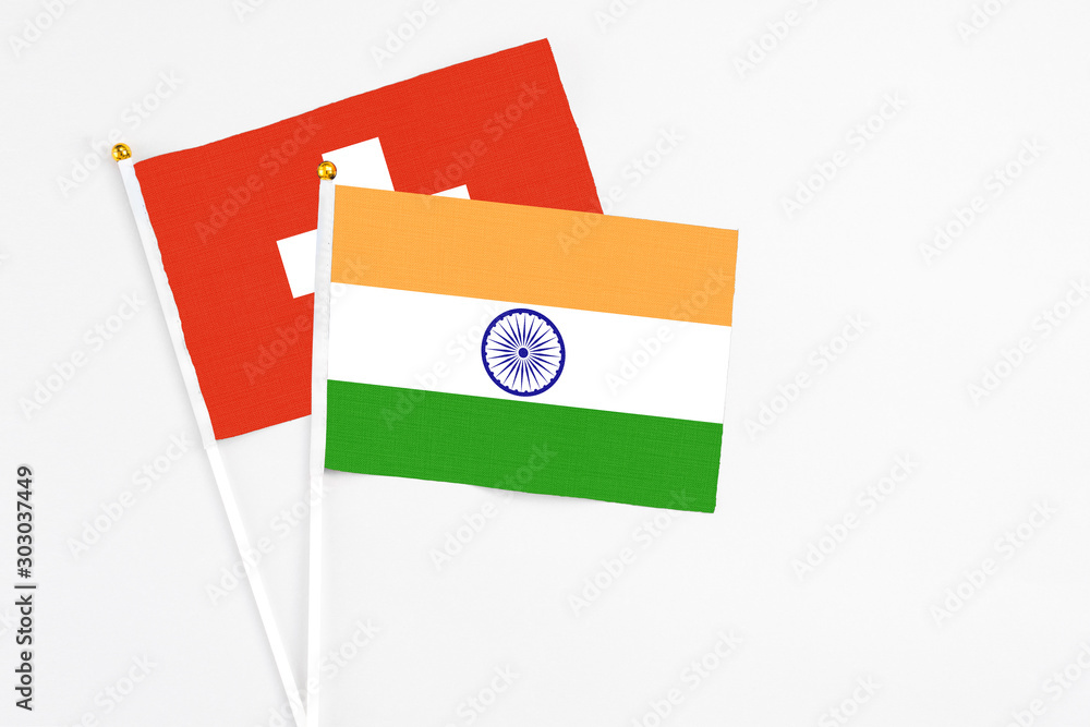 India and Switzerland stick flags on white background. High quality fabric, miniature national flag. Peaceful global concept.White floor for copy space. India and Switzerland stick flags on white background. High quality fabric, miniature national flag. Peaceful global concept.White floor for copy space.