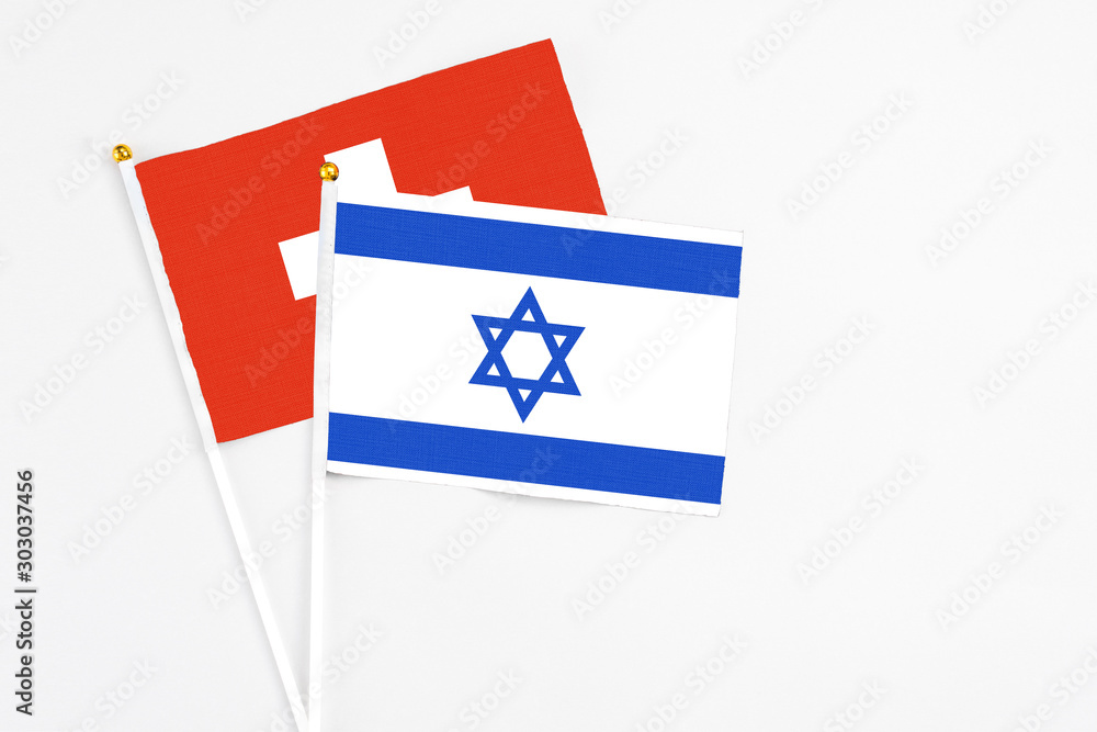 Israel and Switzerland stick flags on white background. High quality fabric, miniature national flag. Peaceful global concept.White floor for copy space. Israel and Switzerland stick flags on white background. High quality fabric, miniature national flag. Peaceful global concept.White floor for copy space.