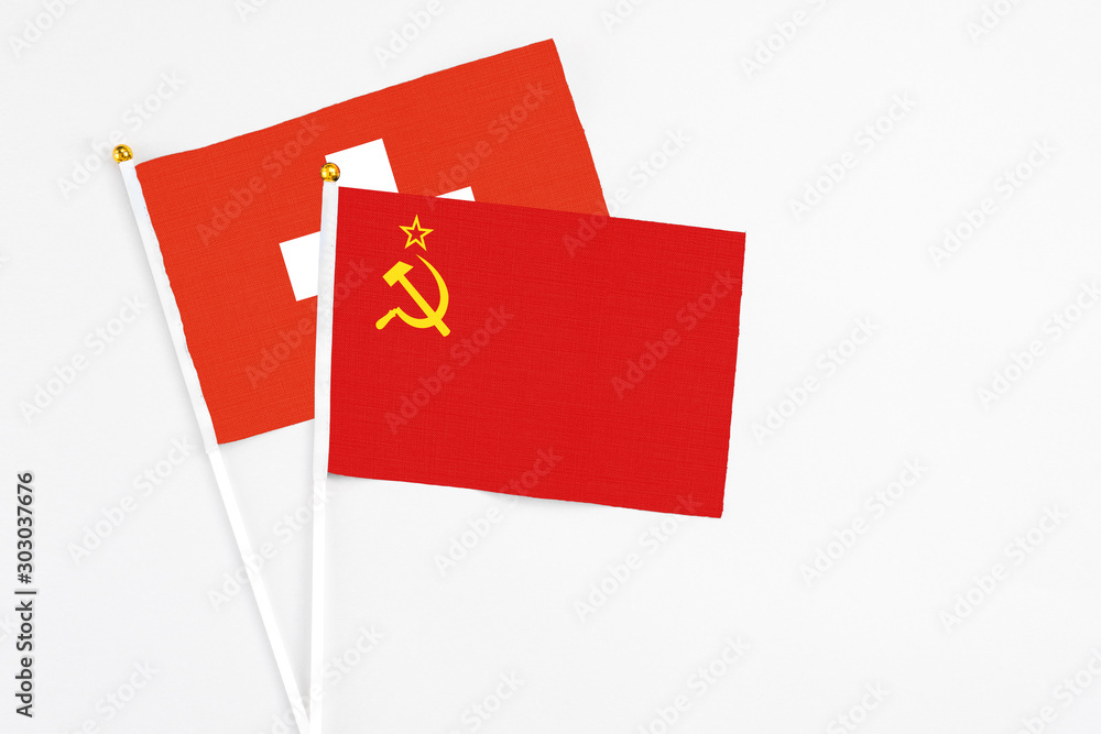 Soviet Union and Switzerland stick flags on white background. High quality fabric, miniature national flag. Peaceful global concept.White floor for copy space. Soviet Union and Switzerland stick flags on white background. High quality fabric, miniature national flag. Peaceful global concept.White floor for copy space.