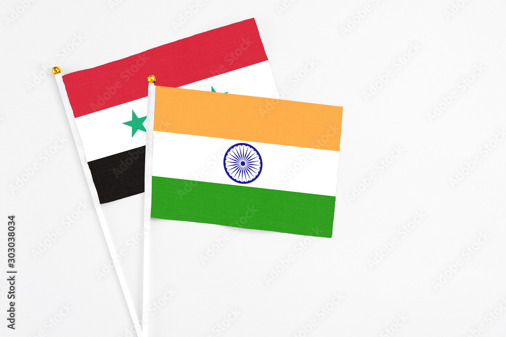 India and Syria stick flags on white background. High quality fabric, miniature national flag. Peaceful global concept.White floor for copy space. India and Syria stick flags on white background. High quality fabric, miniature national flag. Peaceful global concept.White floor for copy space.