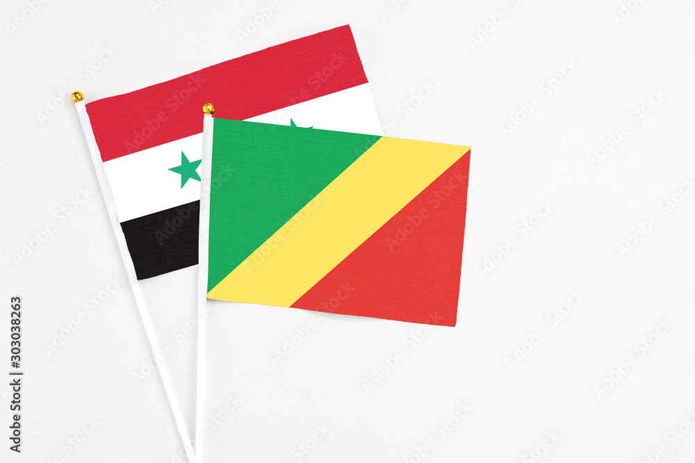 Republic Of The Congo and Syria stick flags on white background. High quality fabric, miniature national flag. Peaceful global concept.White floor for copy space. Republic Of The Congo and Syria stick flags on white background. High quality fabric, miniature national flag. Peaceful global concept.White floor for copy space.