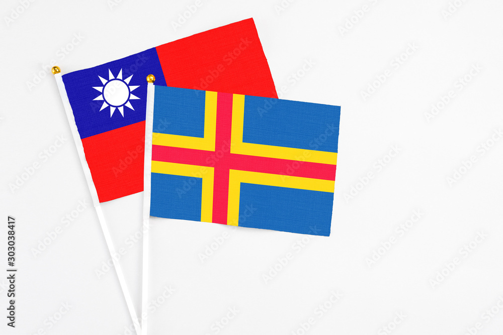 Aland Islands and Taiwan stick flags on white background. High quality fabric, miniature national flag. Peaceful global concept.White floor for copy space.