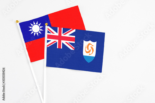 Anguilla and Taiwan stick flags on white background. High quality fabric, miniature national flag. Peaceful global concept.White floor for copy space.