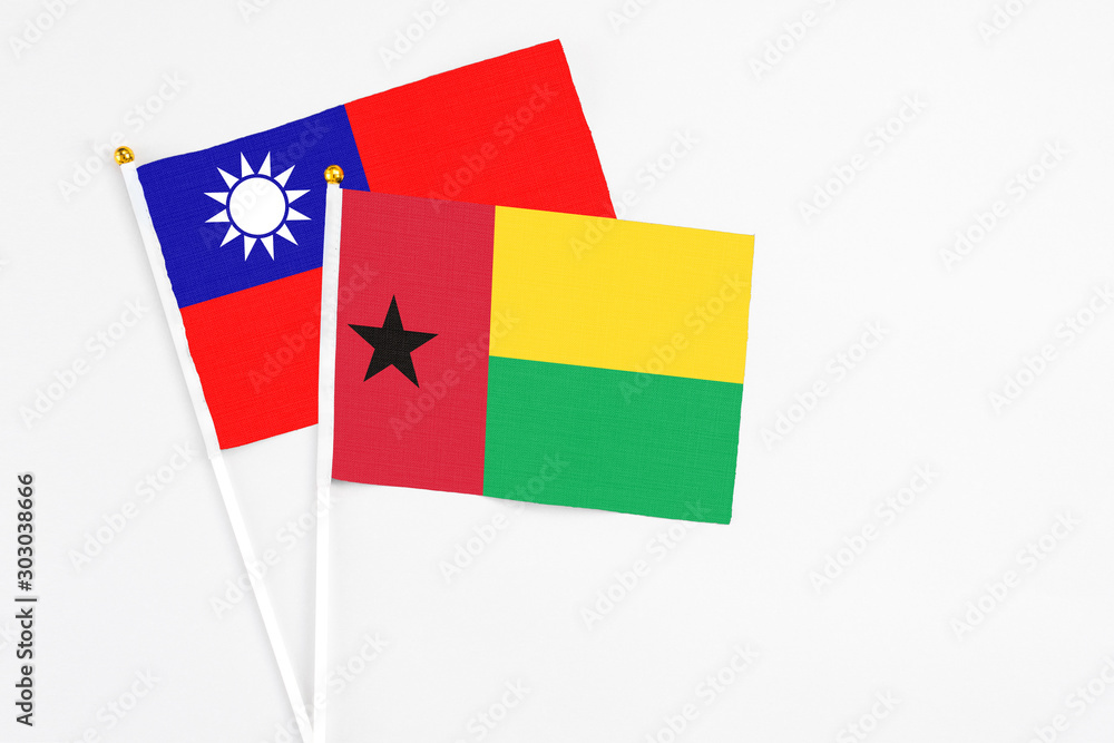 Guinea Bissau and Taiwan stick flags on white background. High quality fabric, miniature national flag. Peaceful global concept.White floor for copy space. Guinea Bissau and Taiwan stick flags on white background. High quality fabric, miniature national flag. Peaceful global concept.White floor for copy space.