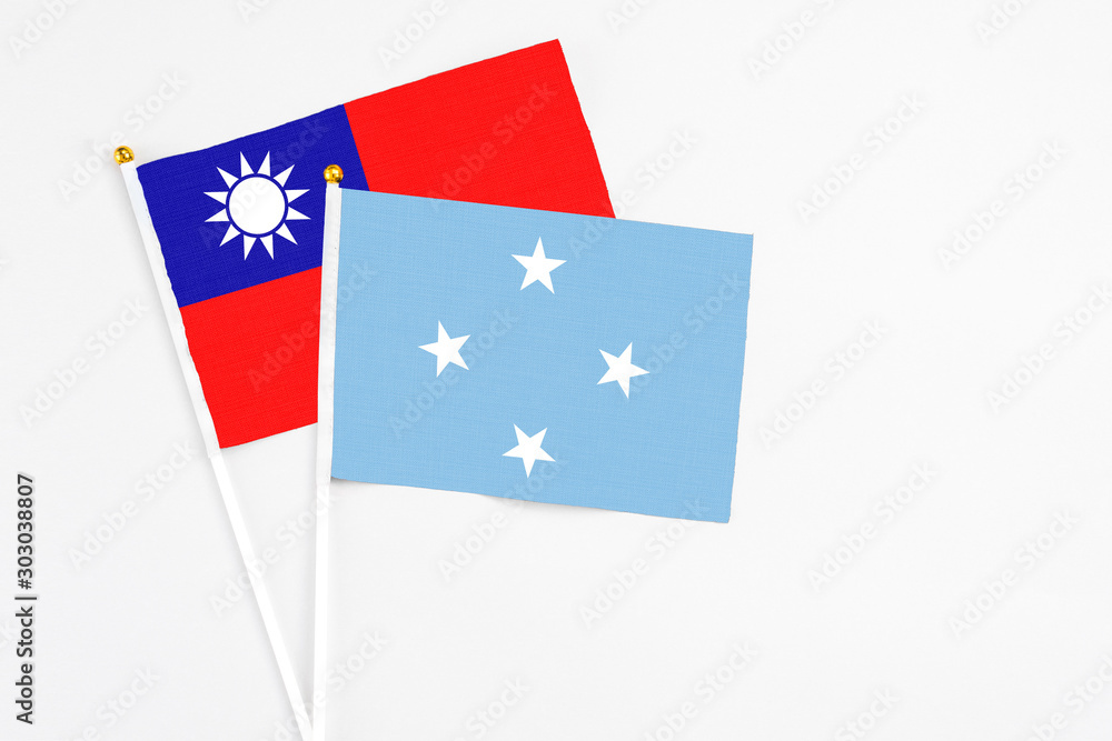 Micronesia and Taiwan stick flags on white background. High quality fabric, miniature national flag. Peaceful global concept.White floor for copy space. Micronesia and Taiwan stick flags on white background. High quality fabric, miniature national flag. Peaceful global concept.White floor for copy space.