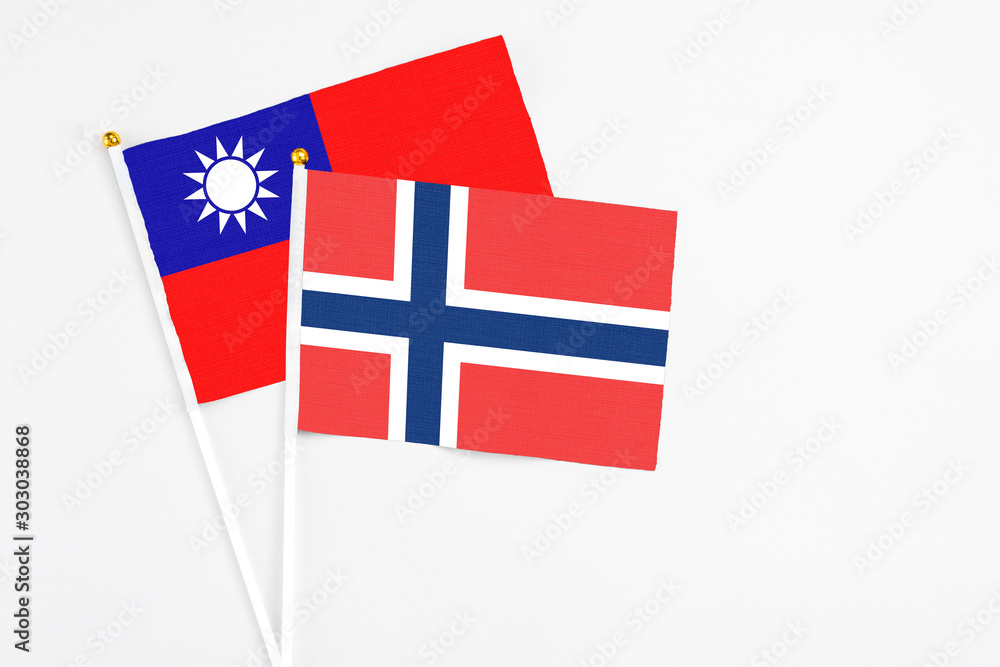 Norway and Taiwan stick flags on white background. High quality fabric, miniature national flag. Peaceful global concept.White floor for copy space.