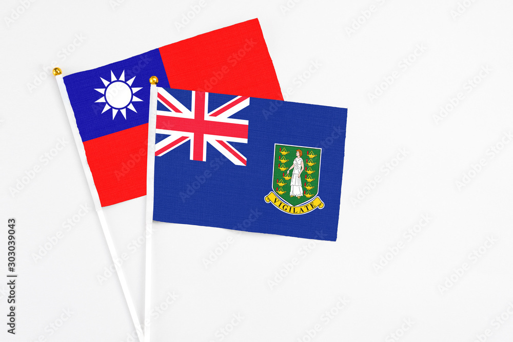 Fototapeta premium British Virgin Islands and Taiwan stick flags on white background. High quality fabric, miniature national flag. Peaceful global concept.White floor for copy space.
