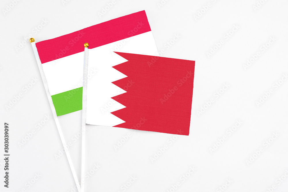 Bahrain and Tajikistan stick flags on white background. High quality fabric, miniature national flag. Peaceful global concept.White floor for copy space. Bahrain and Tajikistan stick flags on white background. High quality fabric, miniature national flag. Peaceful global concept.White floor for copy space.