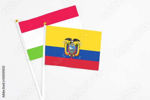Ecuador and Tajikistan stick flags on white background. High quality fabric, miniature national flag. Peaceful global concept.White floor for copy space.