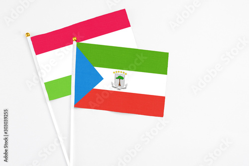 Equatorial Guinea and Tajikistan stick flags on white background. High quality fabric, miniature national flag. Peaceful global concept.White floor for copy space.