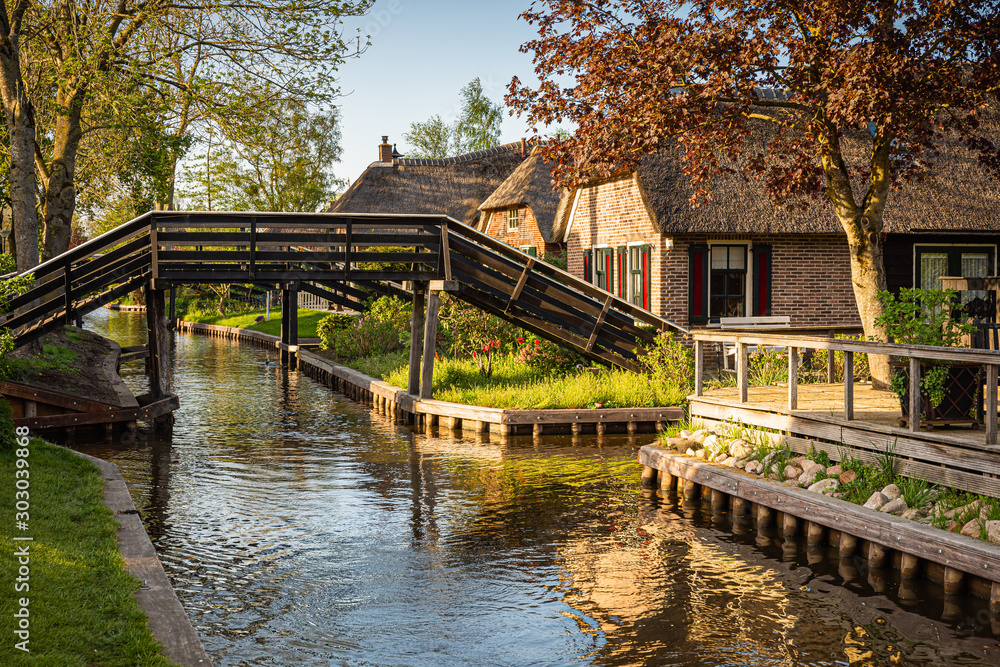 Lovely landscape along canal with footbridges and picturesque houses, Giethoorn, Netherlands